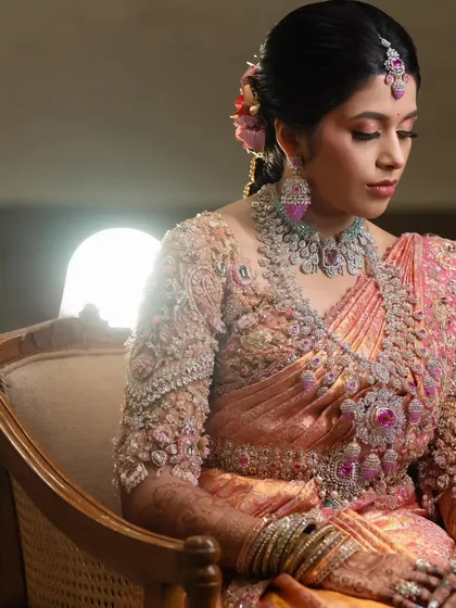 A close-up of the bride's serene expression. The intricate 3D floral embroidery on her blouse is a testament to the craftsmanship that goes into each piece.