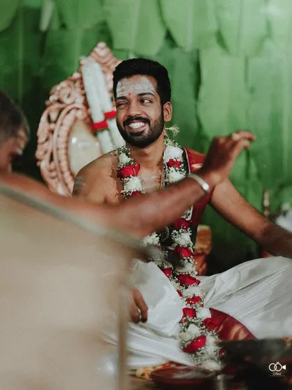 A candid shot of the groom winking during his wedding ceremony, a fun and personal moment.