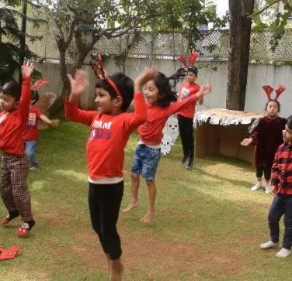 Reindeer games! Children joyfully dancing with reindeer antlers during our outdoor Christmas celebration. Movement and play are part of every festival at Kriya.