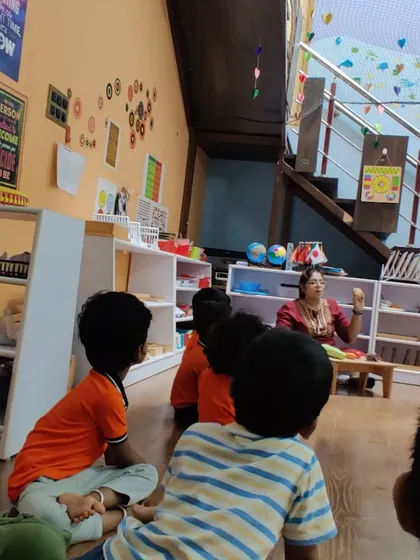 A group discussion about vegetables. We use real objects whenever possible to make learning concrete. The children are engaged, asking questions, and sharing their own knowledge in this interactive session.