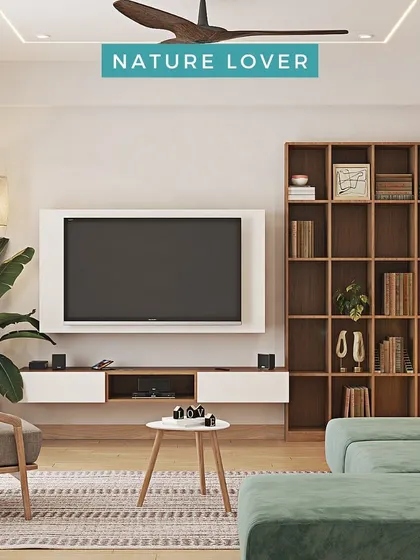 For the nature lover, this living room combines a green sofa, a large wooden bookshelf, and plenty of indoor plants to bring the outdoors in.