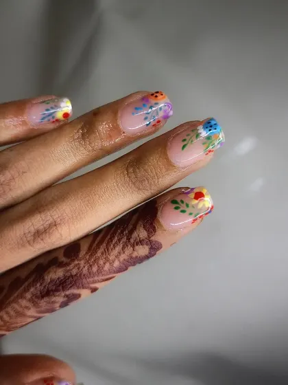 A simple yet beautiful design featuring tiny, colorful hand-painted flowers, perfect for a subtle, spring-inspired look.