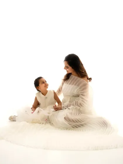 Another angle from this beautiful mother daughter session. The clean white background ensures that the emotional connection between them is the star of the photo.