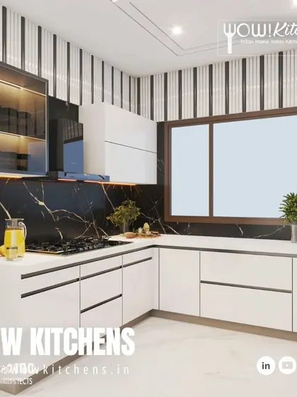 This view shows the efficient layout of the black and white kitchen, with the hob, sink, and prep areas all within easy reach.