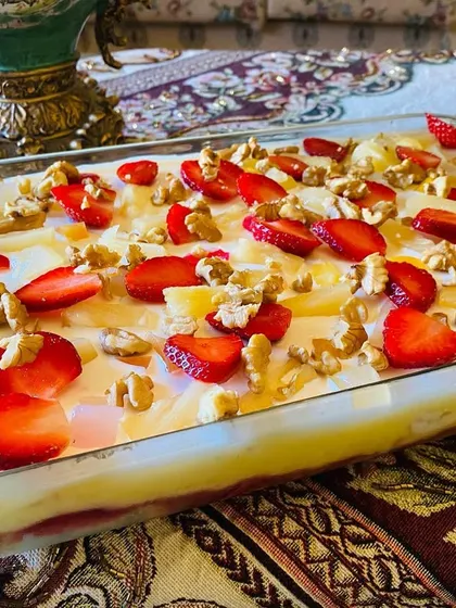 My fruit trifle is full of happiness, with layers of cake, custard, fresh strawberries, pineapple, and walnuts.