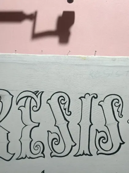 A close-up of the line art for the word "Resist," showing the clean, decorative swirls and consistent thickness of the hand-drawn letters.