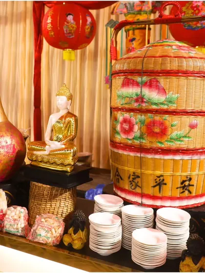 A close-up of the decor at our Pan-Asian station, featuring a Buddha statue and a traditional tiered bamboo basket. These details help transport guests on a culinary odyssey of innovation.
