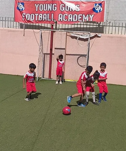 A young girl takes control of the ball, showing the confidence and skill we build in all our players.