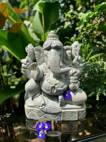 Our Ganappa statue, adorned with fresh flowers, is shown here as a spiritual protector, perfect for the entrance of a home.