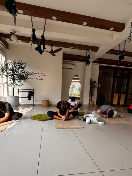 Students in a seated forward fold, a moment of quiet introspection during class.