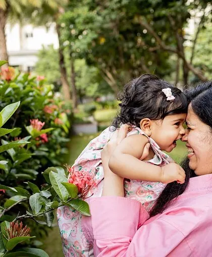 A sweet nose-to-nose moment between a mother and her daughter in the garden. Black and white enhances the feeling of connection.