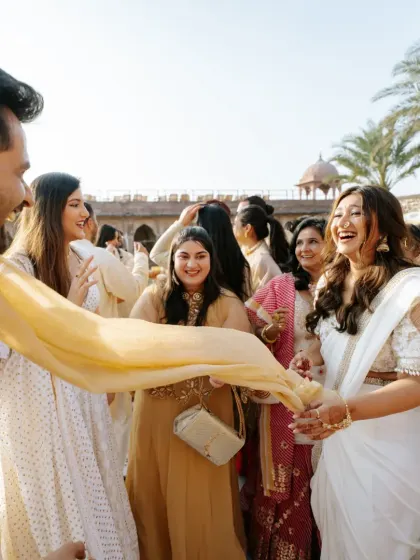 The bride's sister enjoying the festivities at the Haldi ceremony, showcasing the fun family moments we love to capture.