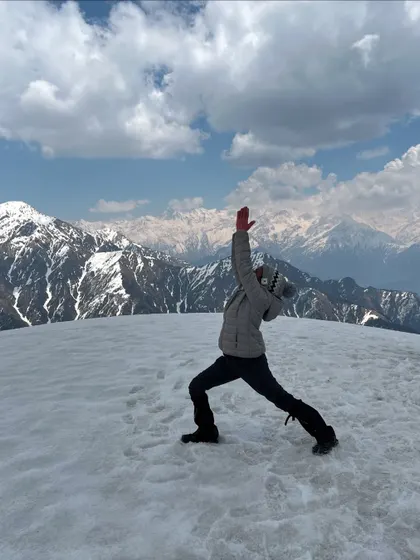 Reaching for the sky in Viparita Virabhadrasana, the reverse warrior pose. This posture feels expansive and liberating, especially when surrounded by the endless peaks of the Himalayas at 13,000 feet.