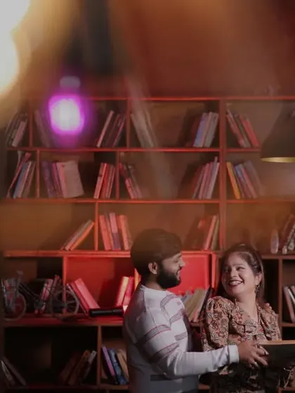 A sweet pre-wedding moment in a library setting. This is a great example of a themed shoot that reflects the couple's shared interests and personality.
