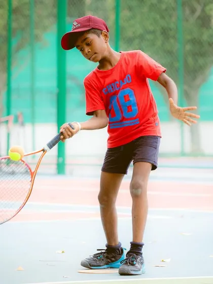 Learning to balance the ball on the racquet is a classic drill for developing feel and hand-eye coordination. It's one of the many fun exercises we use to engage our youngest players in the red ball program.