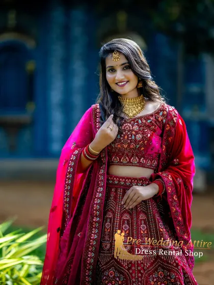 A close-up portrait in the pink and red lehenga, highlighting the intricate embroidery on the blouse.