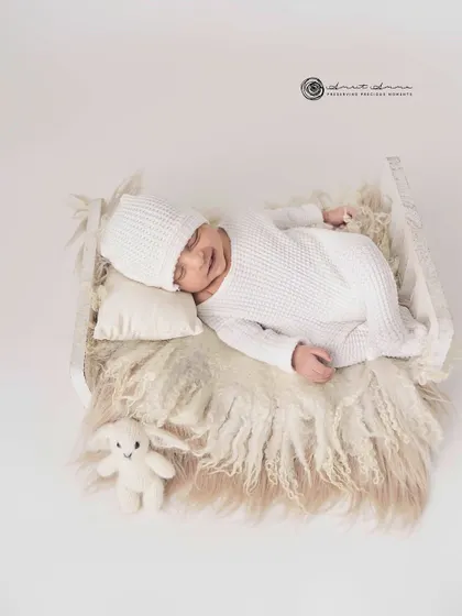 Simplicity at its finest. An all white setup with a cozy knit outfit and a tiny bunny friend creates a pure, timeless, and angelic newborn portrait.