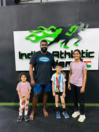 Our coach with a young champion and his family. This little athlete won multiple gold, silver, and bronze medals at his school's sports meet.