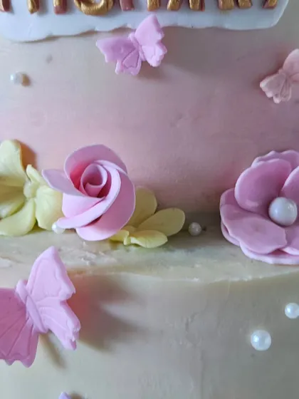 Another detail from the garden cake, this shot highlights the tiny edible butterflies and the delicate sugar pearls that add a touch of shimmer.