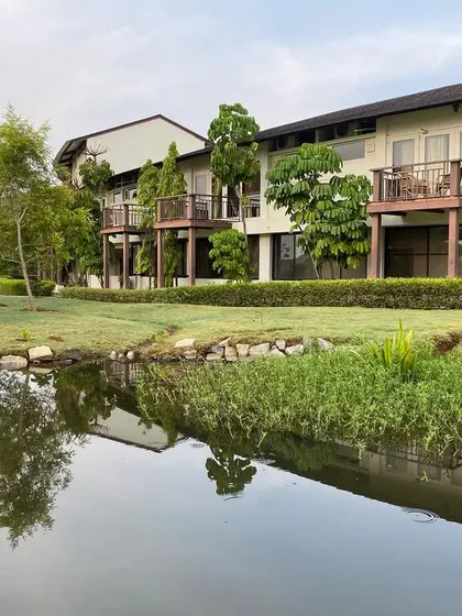 Our guest accommodations are designed with private balconies that open up to views of the water and gardens. This image shows the seamless blend of indoor comfort and outdoor serenity.