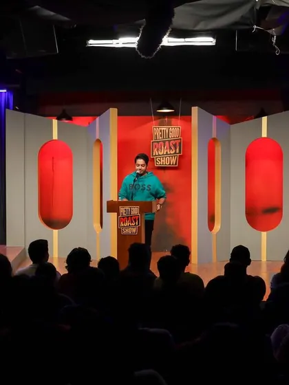 A wide view of the Pretty Good Roast Show, showing the full panel and the audience, which is great for promotional use.