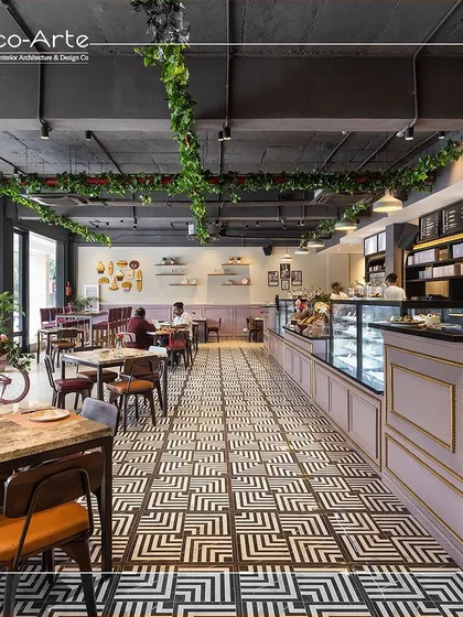 Step into a world of elegance at Amelia, where every corner tells a story of refined design and modern luxury. The geometric flooring and hanging greenery create a lasting impression for this cafe.
