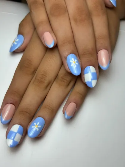 Another view of the celebratory blue nails, showing the fun mix-and-match design. It's a stylish way to show team spirit.