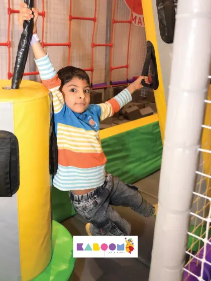 Hanging around and having fun! This obstacle is great for building upper body strength while playing.