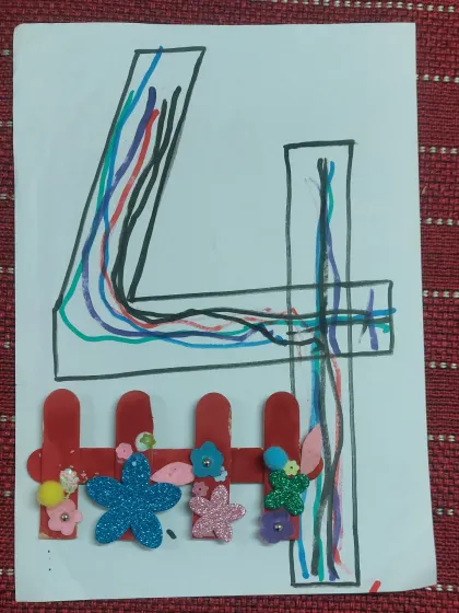 A beautiful craft combining number learning with art. The number '4' is decorated with colorful lines and a fence made of popsicle sticks and foam flowers.