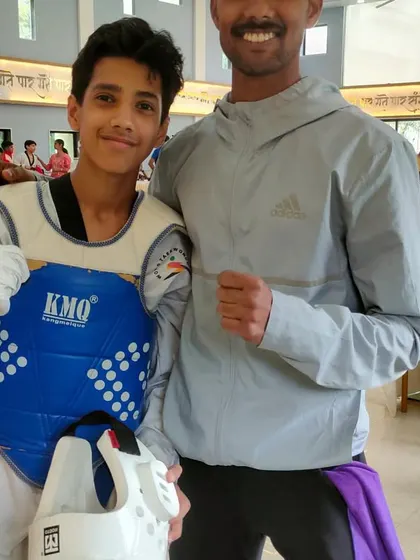 A post match photo with one of my students, still in his sparring gear. The smile on his face after a tough fight says everything about the spirit of Taekwondo.