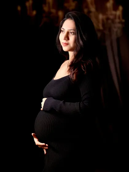 A classic, artistic maternity portrait that celebrates the quiet strength and beauty of motherhood. This is a sample of our fine art studio work, focusing on dramatic lighting and emotion.