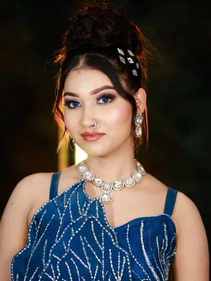 A full-length view of the elegant blue gown and the complementary makeup, showing the student's ability to style a complete look.
