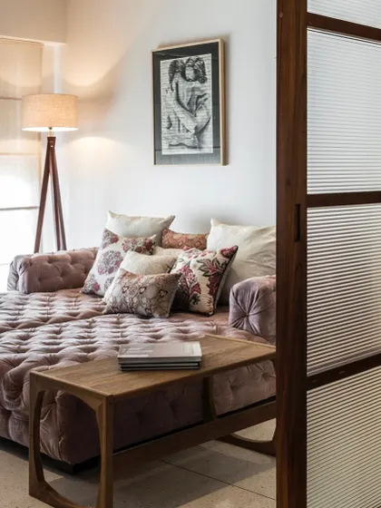 Another view of the cozy den in the Terrazzo Residence, showing the fluted glass sliding door that separates it from the main living area.
