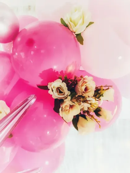 A close-up showing how I incorporate artificial flowers into balloon arrangements for an elegant and textured look.