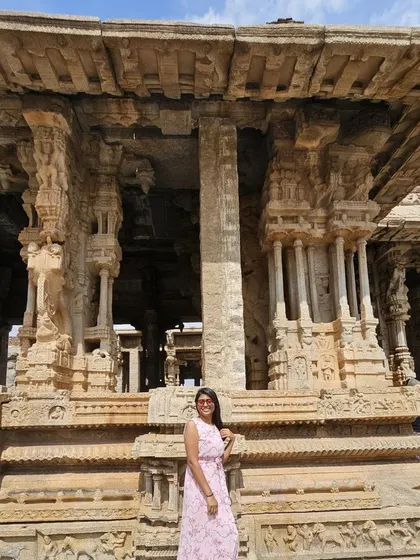 Posing in front of the musical pillars at the Vittala Temple in Hampi.