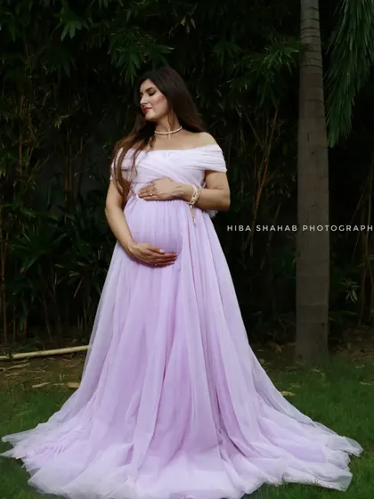 A serene portrait of a mom-to-be in a lavender A-line gown. The soft color and simple, elegant design make it a perfect choice for a peaceful and beautiful maternity shoot.
