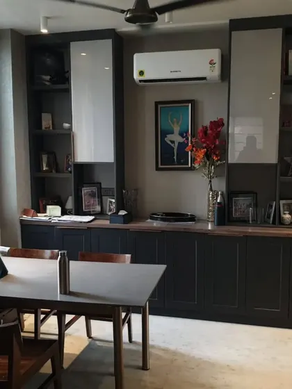 A home office or study area with dark custom cabinetry providing ample storage. The design is both professional and seamlessly integrated into the home's aesthetic.