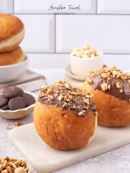 Another angle of the Nutella bombolonis, emphasizing their golden-brown color and generous topping.