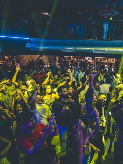 A duplicate shot capturing the wild energy of the crowd under yellow lights. The excitement is so palpable it's worth seeing twice.