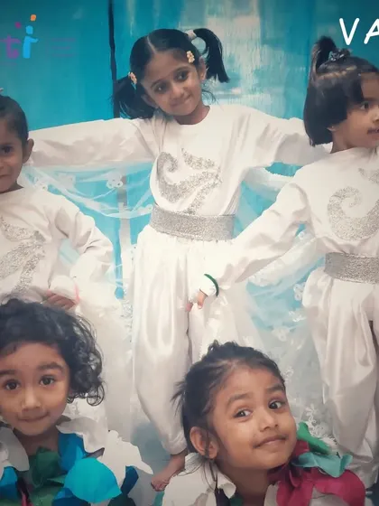 Children in their "Vayu" costumes pose during a rehearsal for the Annual Day, their excitement palpable.