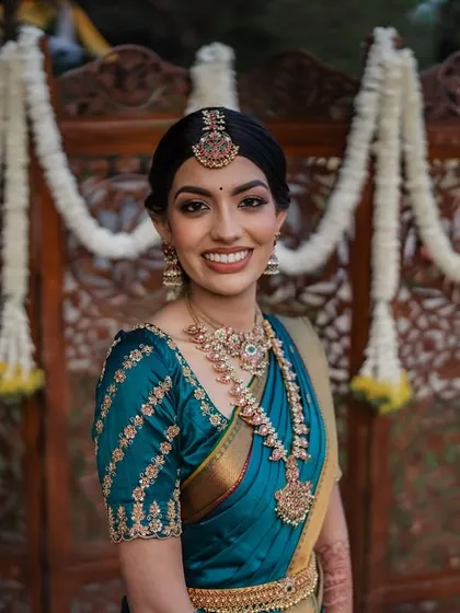 A radiant bride in her teal Kanjeevaram saree. We love capturing the vibrant colors and rich traditions of South Indian weddings.
