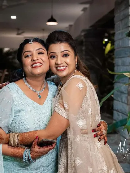 The two sisters, Ashwini and her sister, sharing a warm hug.