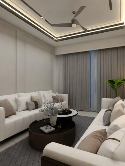This living room setup uses an L-shaped sofa to maximize seating in a compact area. The wall paneling and cove lighting in the false ceiling add a sense of height and luxury to the room.