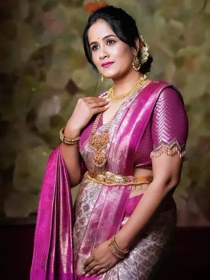 Another elegant shot of Hemalatha, showcasing the beautiful drape of the pink and silver brocade saree.