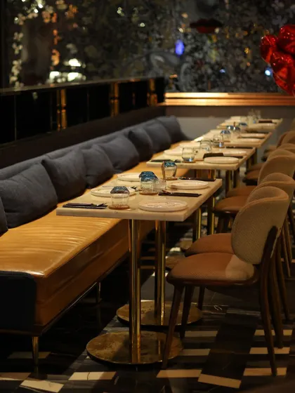 The dining setup at the lounge, with neatly arranged tables and comfortable seating, ready for guests to arrive.