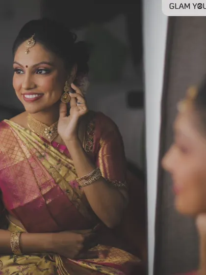 A candid moment of the bride admiring her final look. My goal is always to create a makeover that looks minimal, dewy, and skin-like, ensuring the bride feels happy and confident.