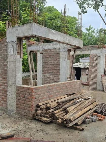 **Dwelling in Frames, Ahmedabad:** The raw structure of the house, showing the concrete frame and brick infill walls. This stage reveals the home's fundamental geometry and its relationship with the site.