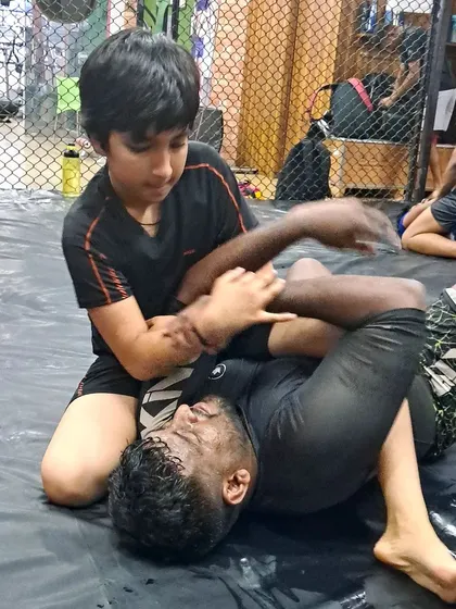A young student learning to control an opponent from the top position. We teach grappling to all ages, building a strong foundation early.