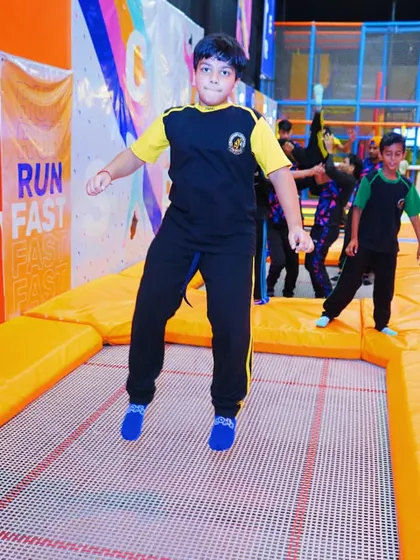 A student from the school trip catches some air on the main trampoline court. The joy of jumping is universal.