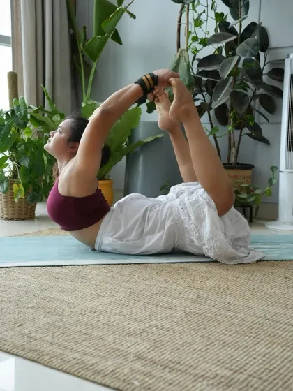 Dhanurasana (Bow Pose), a powerful backbend that strengthens the entire back of the body and opens the front.